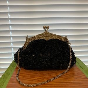 Black bead and sequin handbag with short, silver chain strap.
